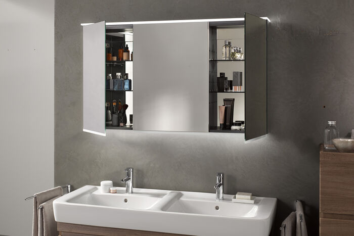 Waschplatz mit Doppelwaschbecken und beleuchtetem Spiegelschrank.