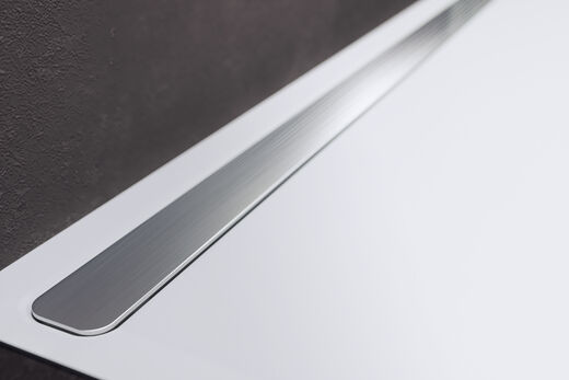 Kaldewei Nexsys Weiße Kaldewei Nexys Duschfläche mit metallener Ablaufrinne.