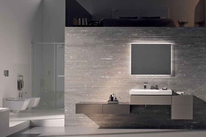 Edles Designer-Komplettbad Xeno2 von Geberit mit Waschplatz und räumlich um die Ecke gelegenem WC/Bidet und Dusche.