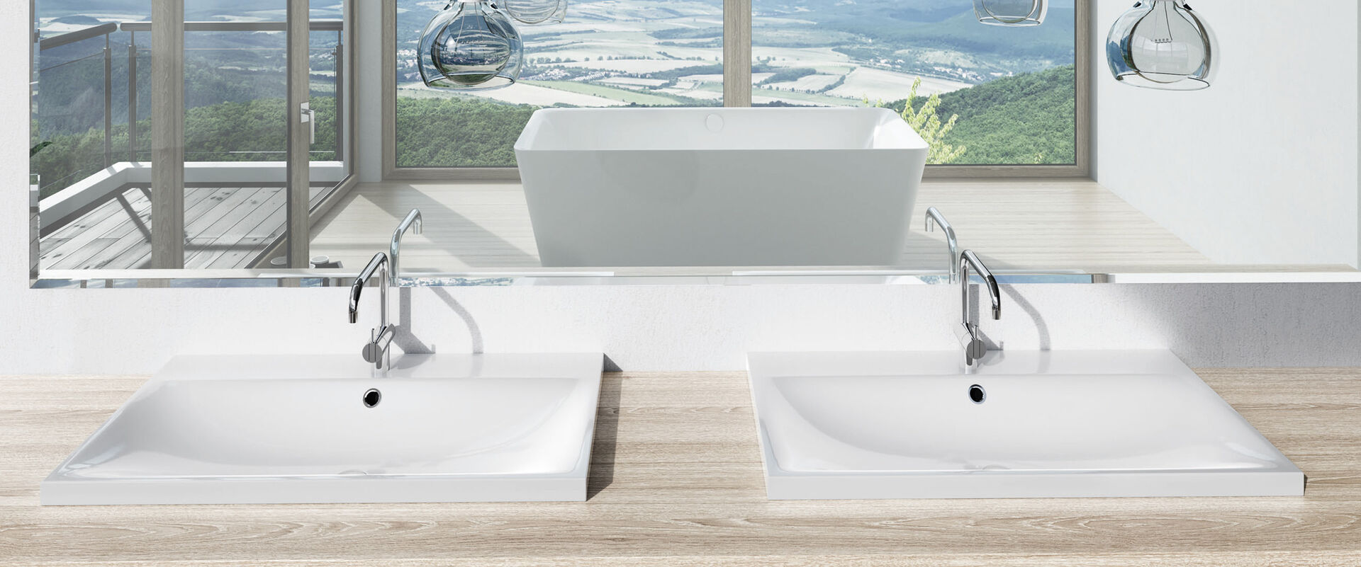 Waschbecken Silenico von Kaldwei, die auf einem hölzernen Waschtisch montiert sind. Im Hintergrund hängt ein Spiegel, der das restliche Badezimmer zeigt. Inmitten des Badezimmers steht eine Badewanne.