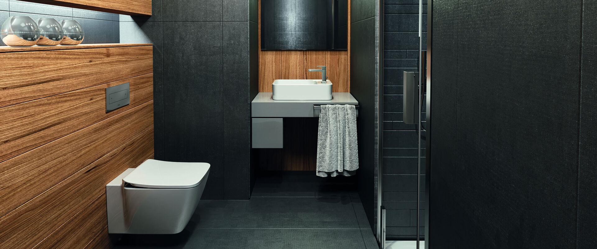 Auch in kleinen Abmessungen die Top Lösung: Hier zu sehen die Konsole Adapto von Ideal Standard mit Aufsatzwaschtisch in einem eleganten Gäste-WC mit Holzoptik.