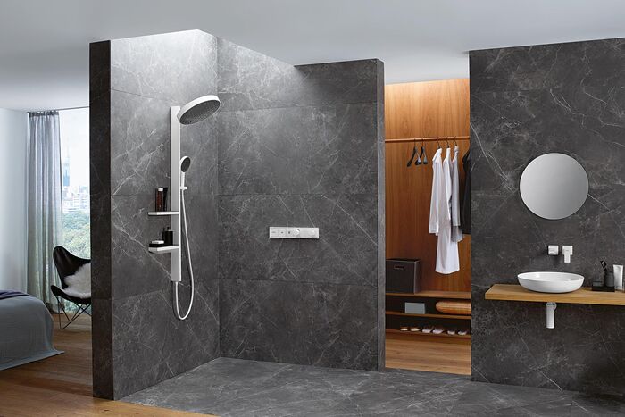 Elegantes Badezimmer in Anthrazit und Holz mit einem großzügigen, bodenebenen Duschbereich ausgestattet mit Rainfinity-Brausen und dem System "Showerpipe" von hansgrohe.