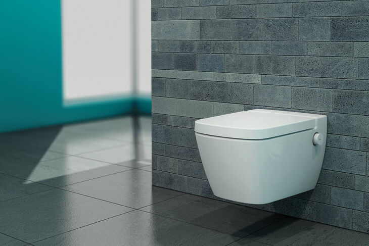 TECE TECEone Wandhängendes Dusch-WC von TECE aus der Modellreihe TECEone an grauer Fliesenwand. Seitlich ist einer der beiden integrierten Drehknöpfe zur Bedienung zu sehen.