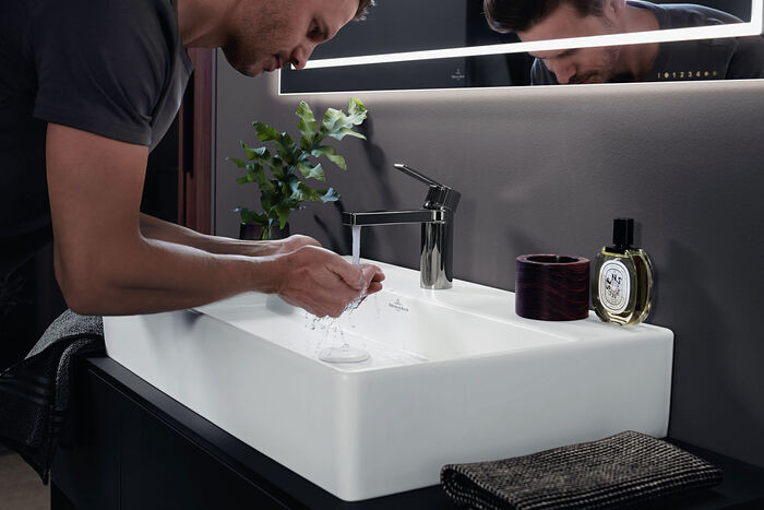Großaufnahme eines Mannes über den Waschtisch gebeugt beim Händewaschen in einem Memento 2.0 Keramik-Waschbecken von Villeroy & Boch.
