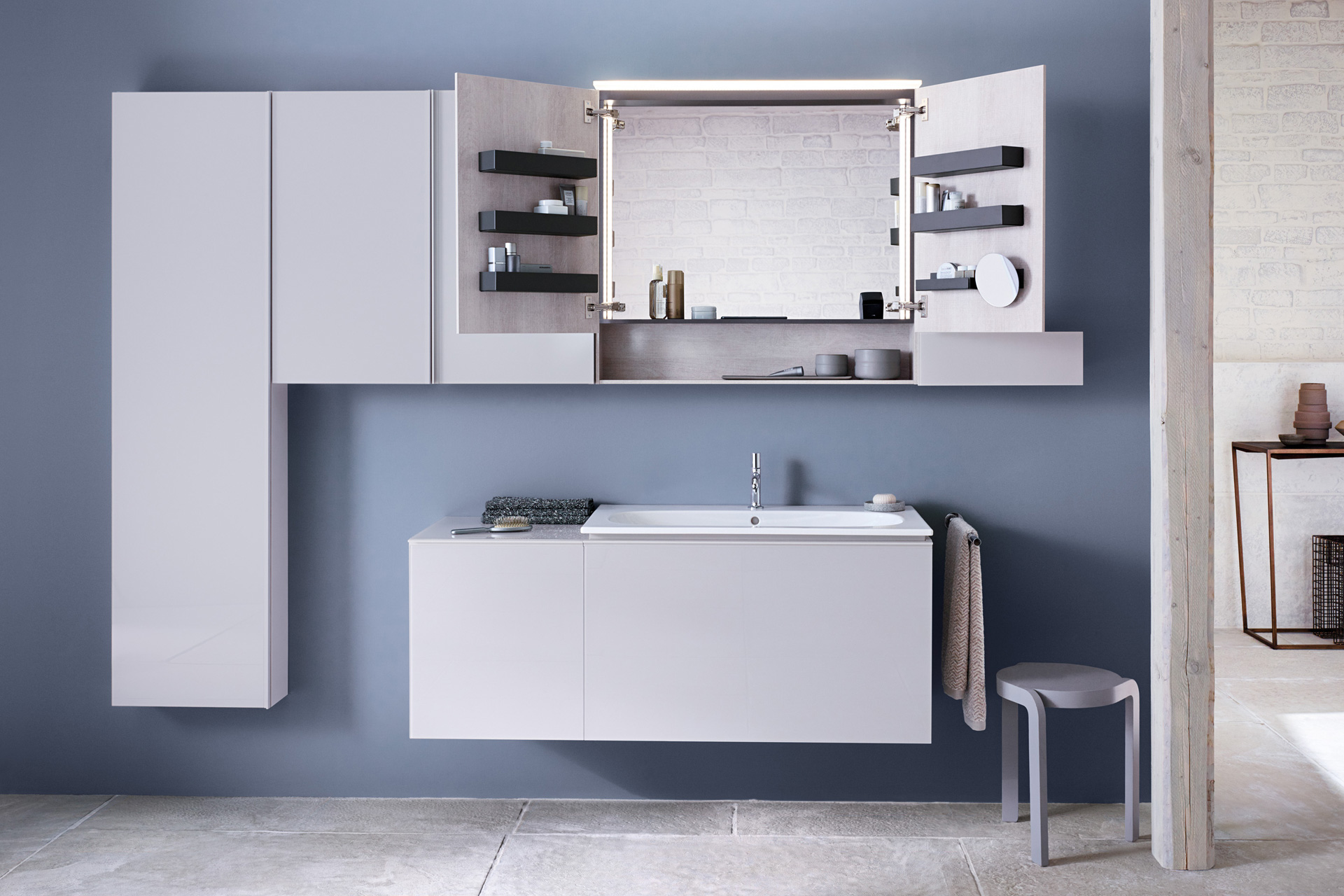 Waschplatz komplett. Offener Spiegelschrank über Einbauwaschbecken und Badmöbel mit seitlich wandmontierten Schränken.